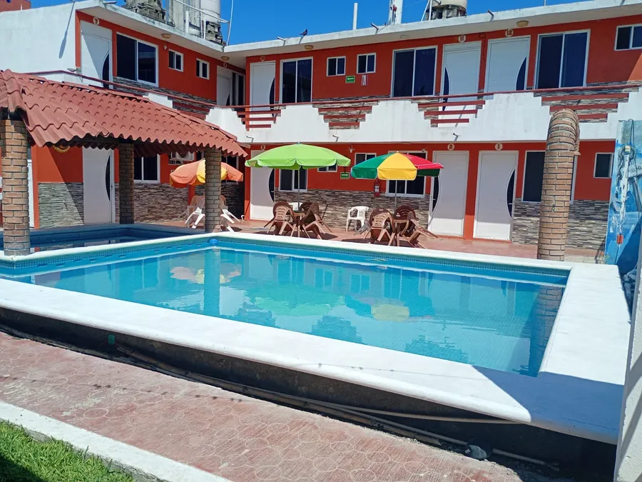 Otra vista de la alberca de Hotel Valeria con sombrillas de colores