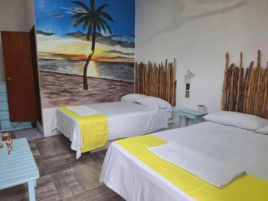 Habitación con mural de palmera al atardecer de Hotel Nautilus en Tecolutla