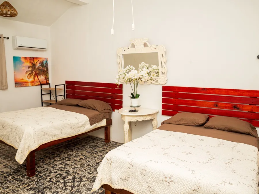Habitación de Casa Vacacional Orquídeas con dos camas matrimoniales
